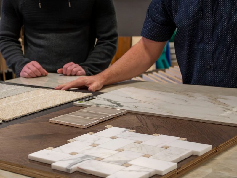 Pioneer Floor Coverings designer showing flooring samples during a free in-home consultation in Southern Utah