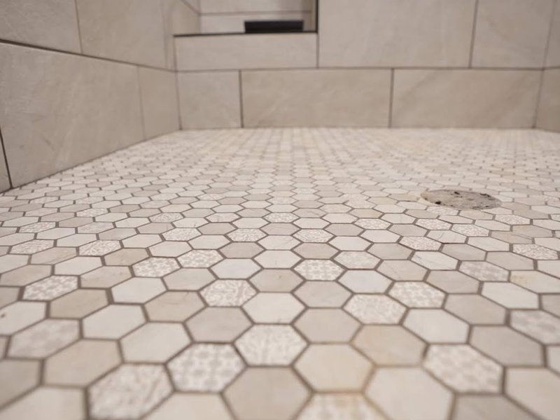 Honeycomb pattern tiles installed in a shower by Pioneer Floor Coverings