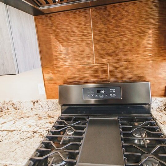 Custom backsplash and range at 'Elements at Sunset' from Pioneer Floor Coverings & Design